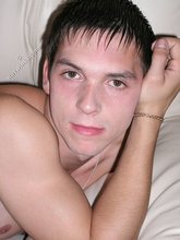 Dark-haired twink spreading his sexy legs on cam