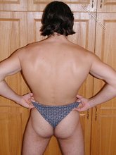 Blue-eyed brunette twink posing naked in his room