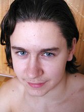 Blue-eyed brunette twink posing naked in his room