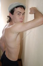 Curly-haired young boy wearing the sluttiest thong