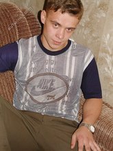 Blond-haired boy posing shirtless in his camo pants