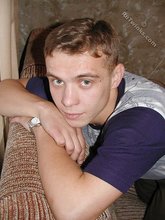 Blond-haired boy posing shirtless in his camo pants