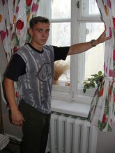Blond-haired boy posing shirtless in his camo pants
