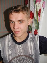 Blond-haired boy posing shirtless in his camo pants