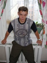Blond-haired boy posing shirtless in his camo pants