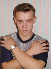 Blond-haired boy posing shirtless in his camo pants