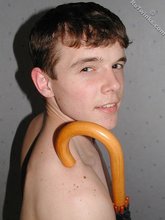 Umbrella-loving young boy doing a handstand on cam
