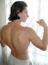 Twink with slicked back hair stripping on camera