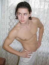 Twink with slicked back hair stripping on camera