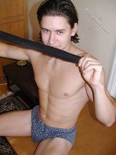 Dark-haired twink teasing with his thick pubes