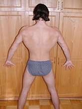 Dark-haired twink teasing with his thick pubes