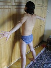 Dark-haired twink teasing with his thick pubes