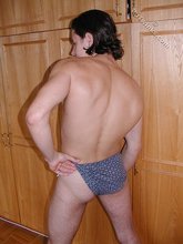 Dark-haired twink teasing with his thick pubes