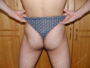 Dark-haired twink teasing with his thick pubes