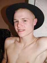 Blond-haired twink fucks pillows and wears hats indoors
