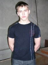 Blue-eyed buff twink posing shirtless and looking smart