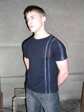 Blue-eyed buff twink posing shirtless and looking smart