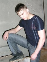 Blue-eyed buff twink posing shirtless and looking smart