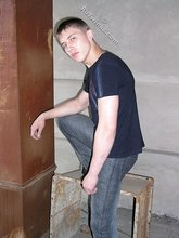 Blue-eyed buff twink posing shirtless and looking smart