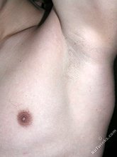 Blue-eyed buff twink posing shirtless and looking smart