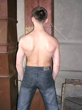 Blue-eyed buff twink posing shirtless and looking smart