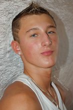 Tanned blue-eyed boy showing his beautiful body here