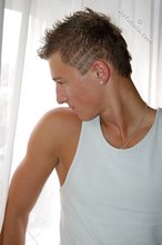 Tanned blue-eyed boy showing his beautiful body here