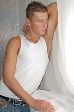 Tanned blue-eyed boy showing his beautiful body here
