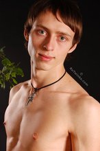 Beautiful-looking twink posing shirtless on a bed