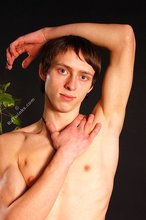 Beautiful-looking twink posing shirtless on a bed
