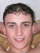 Curly-haired young boy shows his tight booty
