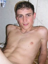 Curly-haired young boy shows his tight booty