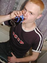 Blond-haired twink drinking and smelling flowers