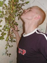 Blond-haired twink drinking and smelling flowers