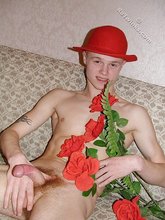 Romantic twink posing with flowers and doing bridges