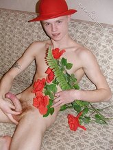 Romantic twink posing with flowers and doing bridges