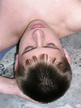 Dark-haired young boy posing in a fetal position