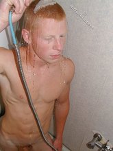 Young redheaded twink taking a shower after cumming