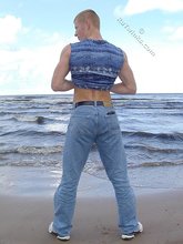 Redheaded guy posing shirtless in the woods