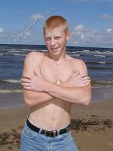 Redheaded guy posing shirtless in the woods