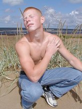 Redheaded guy posing shirtless in the woods