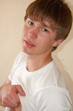 Blond-haired boy takes his shirt off and looks sexy