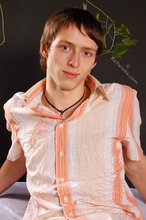 Stylish young boy finally taking his shirt off