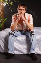 Stylish young boy finally taking his shirt off