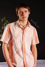 Stylish young boy finally taking his shirt off