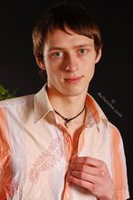 Stylish young boy finally taking his shirt off