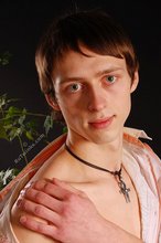 Stylish young boy finally taking his shirt off