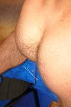 Horny-looking twink shows off his ass on camera