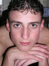 Soulful dark-haired twink posing in the kitchen