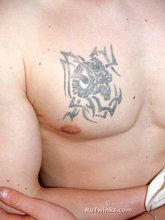 Tatted-up twink shows off in front of a camera